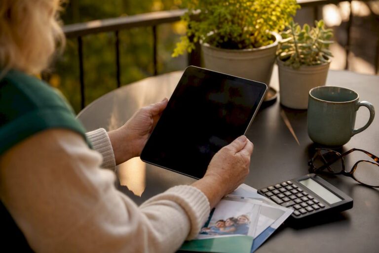 Hands holding tablet among insurance materials