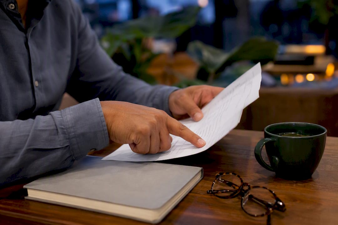 Hands pointing at health insurance policy details