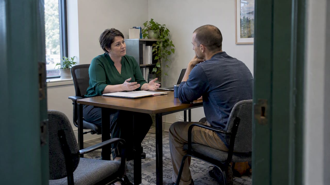 Broker explaining coverage to a self-employed client